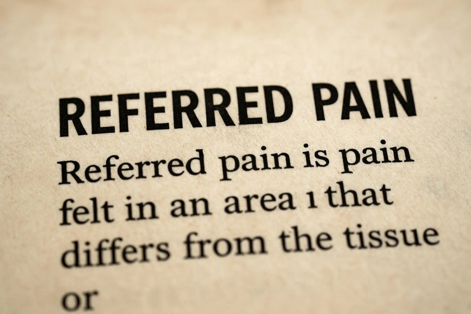 Close-up of a book page showing the heading “REFERRED PAIN” and definition text